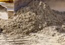 Close up of an earthmoving bulldozer track and blade pushing dirt.