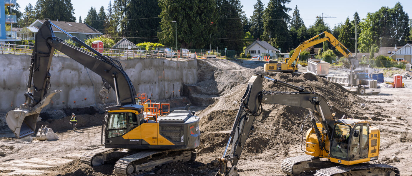 excavators operating at an active urban construction job site